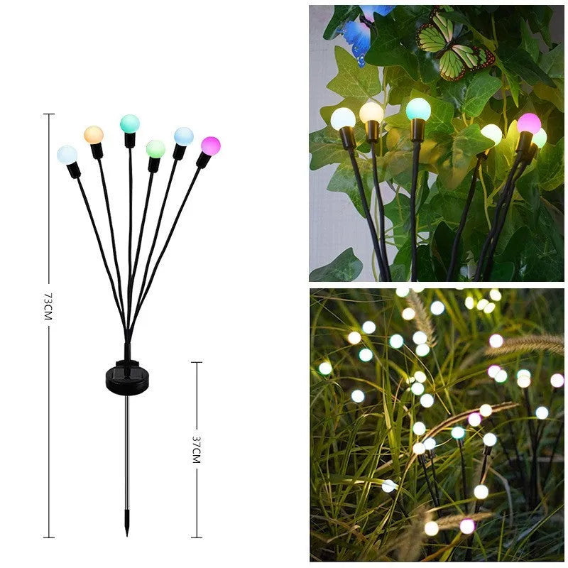 Solar-powered LED garden spike light with multiple glowing heads and a metal ground plug inserted in soil at dusk.