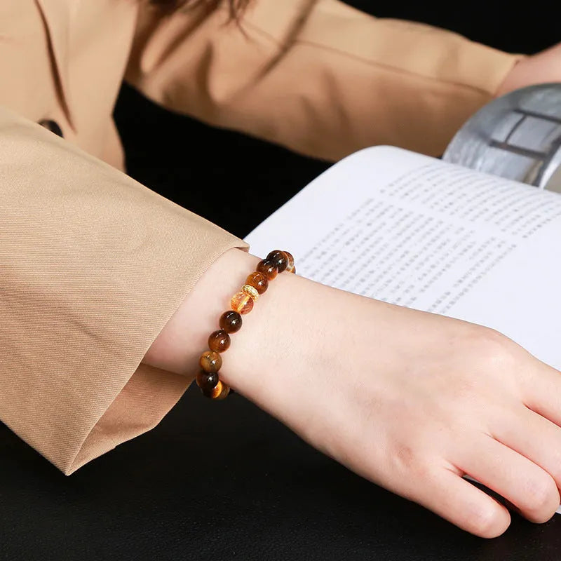 Natural yellow tiger's eye crystal bracelet with mixed yellow tower charms on wrist