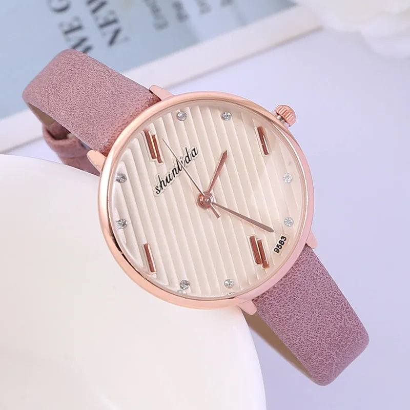 Trendy student watch with round white dial, 32mm diameter, stainless steel buckle on a light background