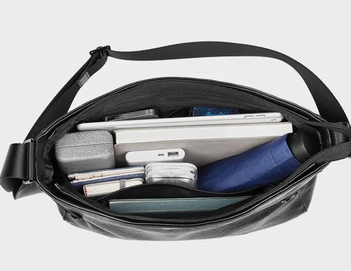 Men's black genuine leather and cowhide crossbody messenger bag with waterproof function and patchwork detail.