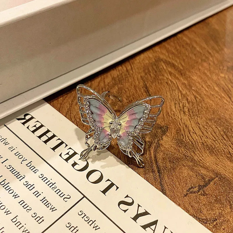 Copper butterfly women's ring with dripping oil texture and an open loop design.