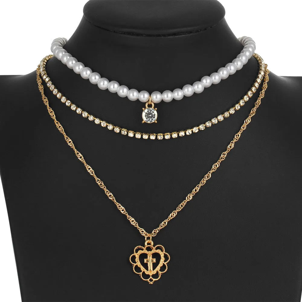 Gold multilayer necklace with heart motif, rhinestones and 6mm imitation pearls, 28-32-40cm chain plus 10cm extension