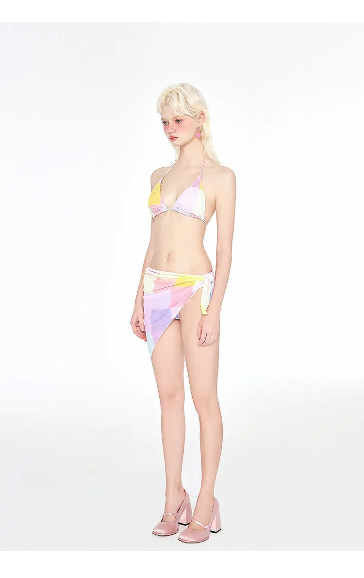 Rainbow pink triangle bikini three-piece swimsuit set on a hanger.