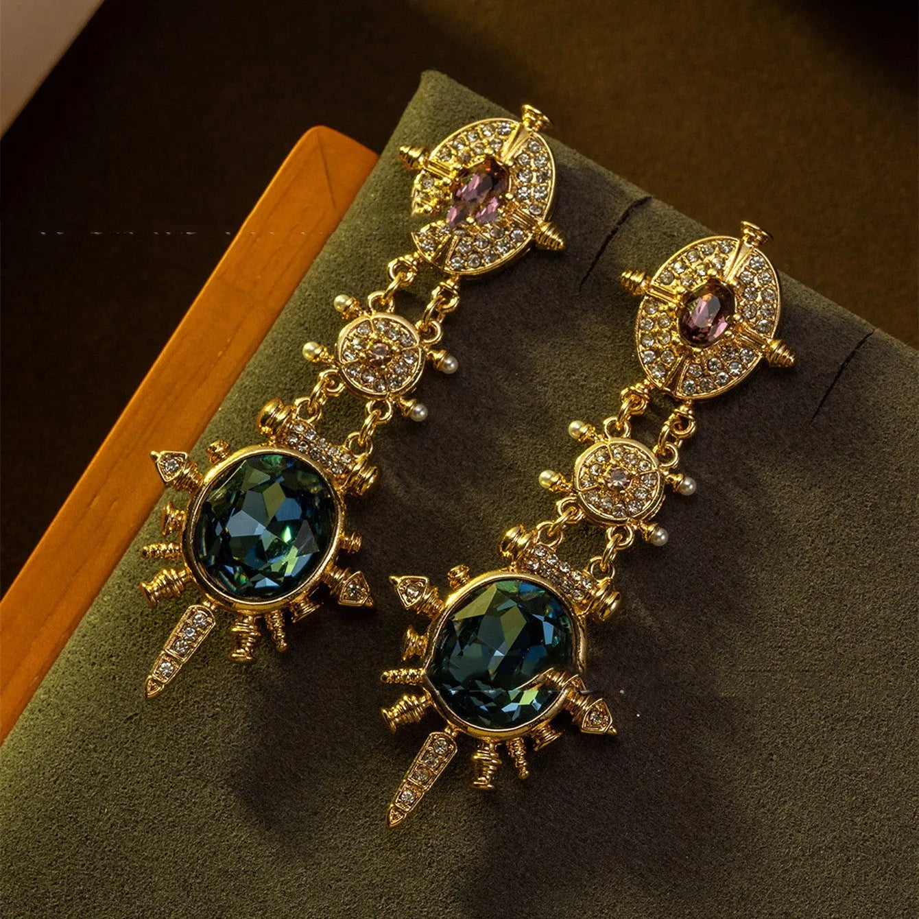 A pair of gold geometric retro-style alloy stud earrings with round diamond-treatment details.