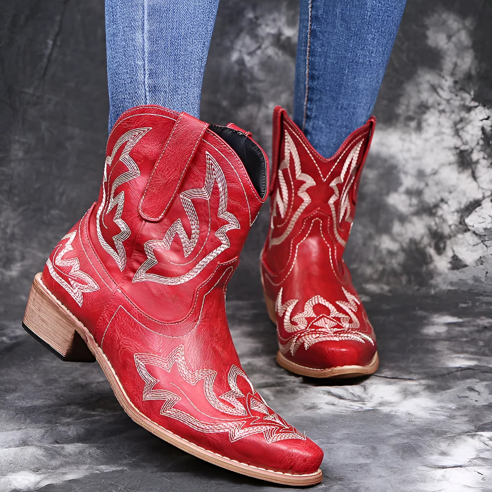 Women's blue embroidered cowboy boots with low wedge heel and pointed toe.