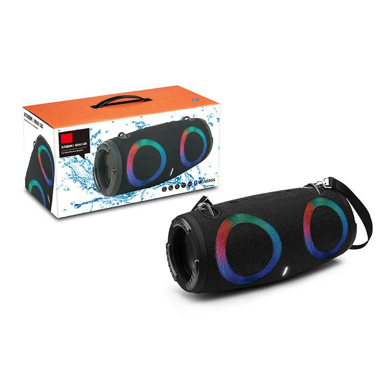 War Drum portable Bluetooth speaker with coloured RGB lights in camouflage colour, showing carrying strap and control buttons.