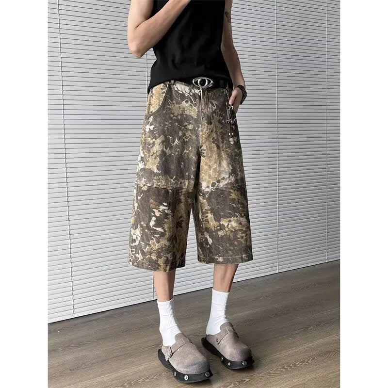 Yellow denim jeans with snake camouflage print and cropped leg length.