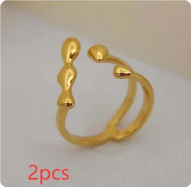 Brass ring with a spherical design on a circular band, shown in gold and silver finishes.