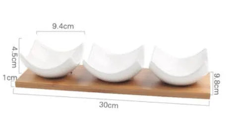 Porcelain ceramic dried fruit dish with compartments on wooden serving board