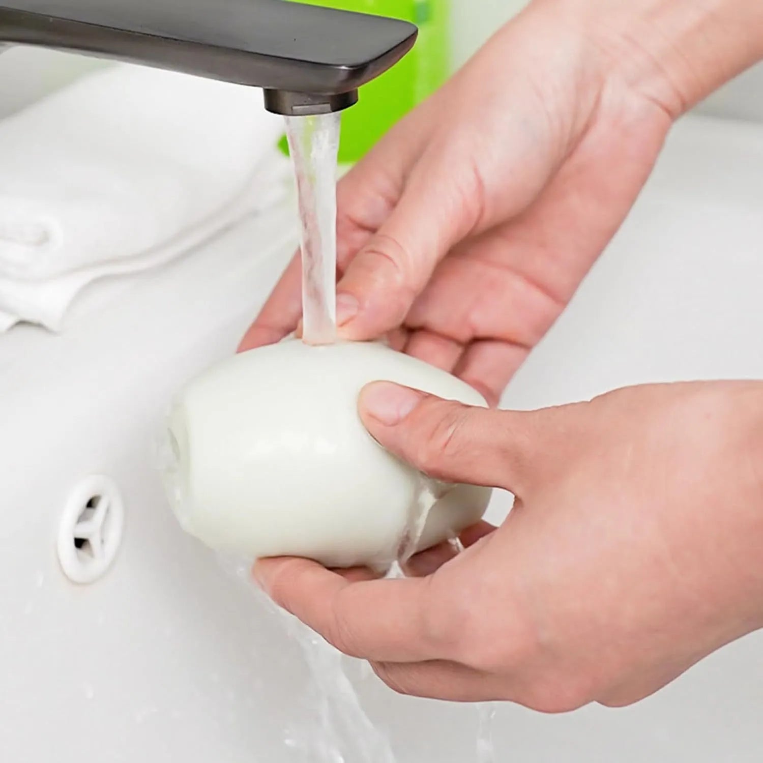 Green and white reusable gel lint roller balls for pet hair removal on fabric