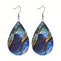 A pair of drop-shaped acrylic earrings with a printed flat branch knot design.