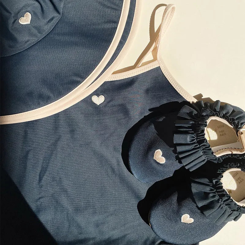 Dark blue split colour baby girl's swimsuit with briefs and split design for swimming.