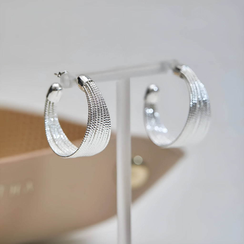 Geometric multi-layer copper earrings with silver or gold electroplated finish, available as studs or clips