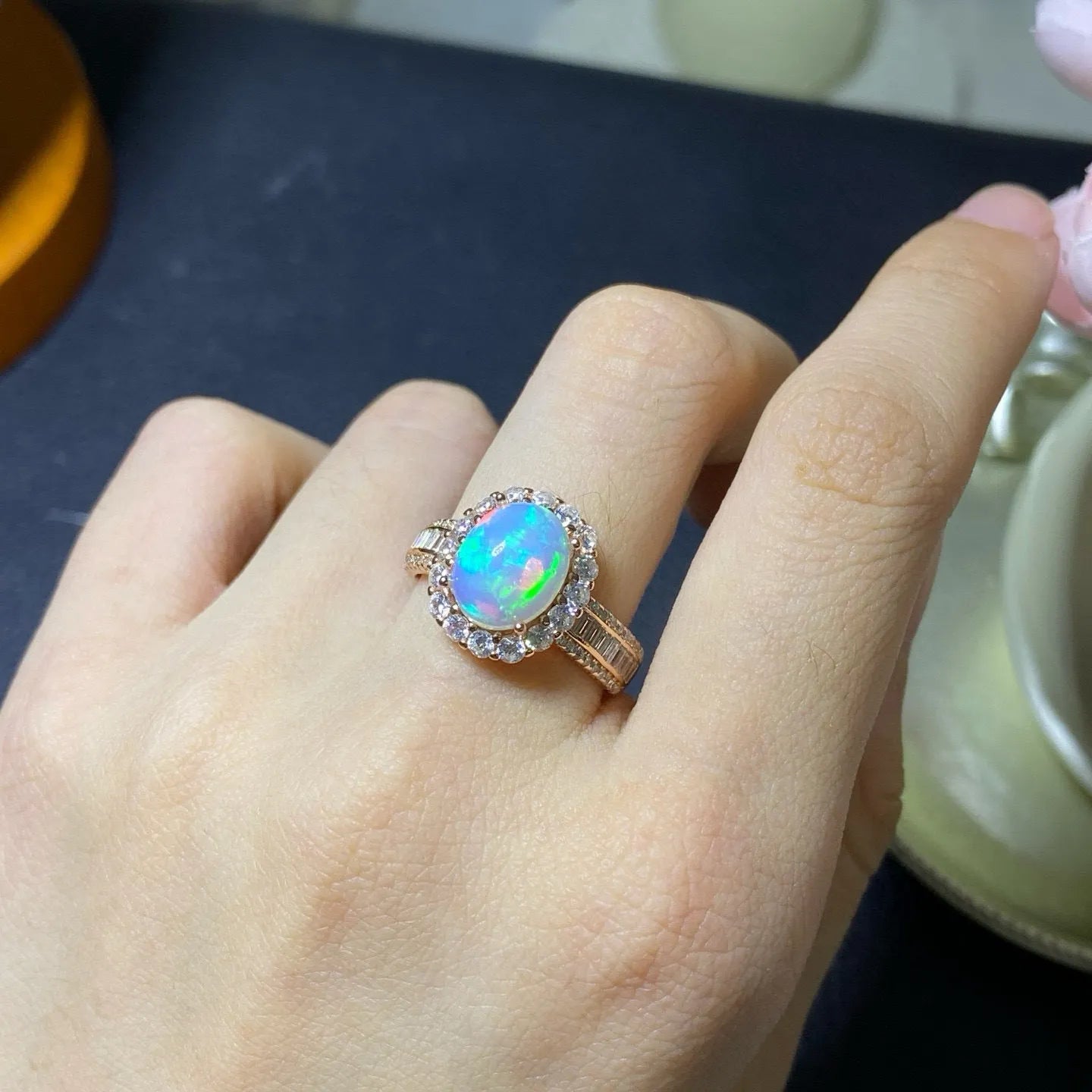 Handmade women's silver opal ring with an opening design, shown in a choice of colour plating.