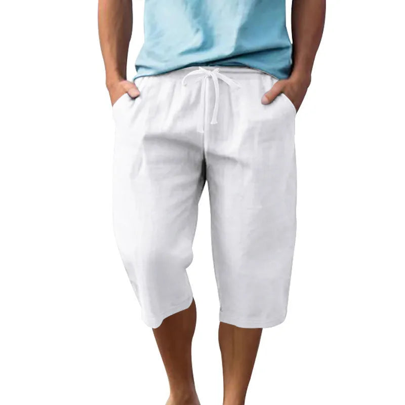 Man wearing light blue linen casual shorts with a cropped length and high waist.