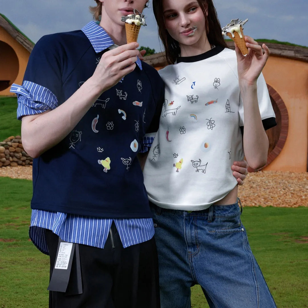 Man wearing a blue loose fit short sleeve shirt with a cartoon print design.