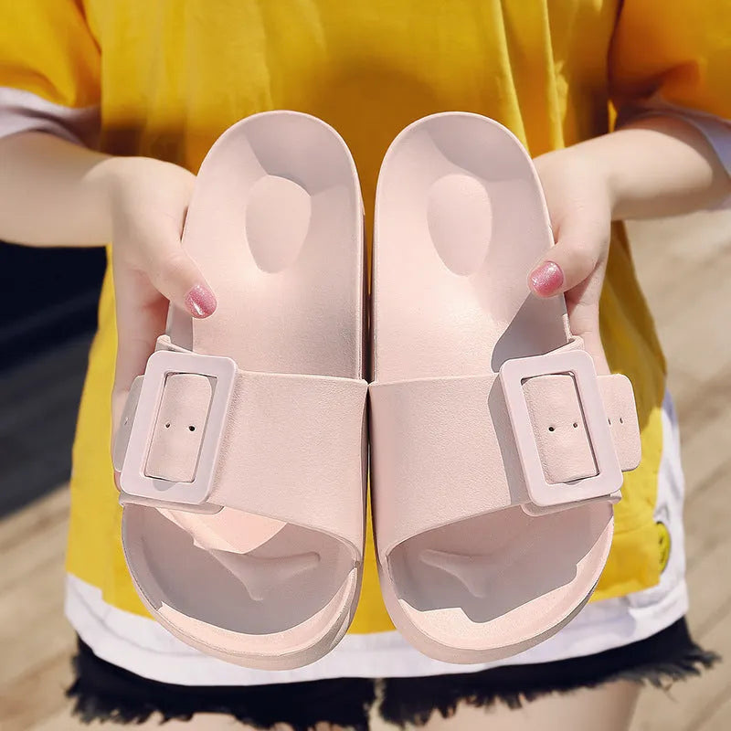 Women's grey blue buckle slipper flip-flops with a soft EVA sole on a plain background.