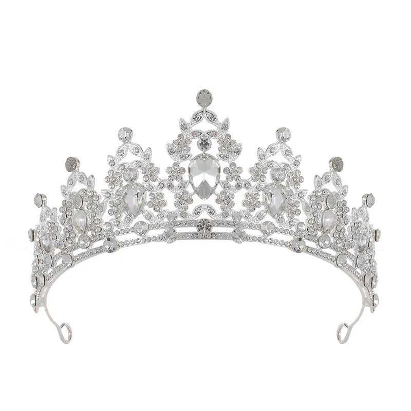 A silver and rhinestone baroque bride crown headdress with intricate detailing on a white background.