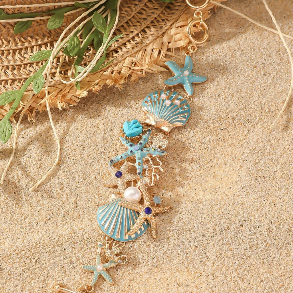 Women's alloy marine-themed bracelet with anchor, shell, and starfish charms in blue, red, or turquoise.