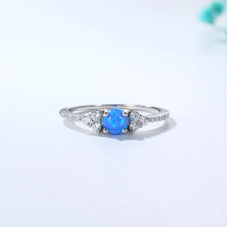 Geometric silver ring with big diamond design, electroplated finish, white or blue opal colour, sizes 5 to 9