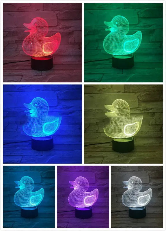 Little yellow duck 3D night light with remote control on a table, showing colourful LED illumination.