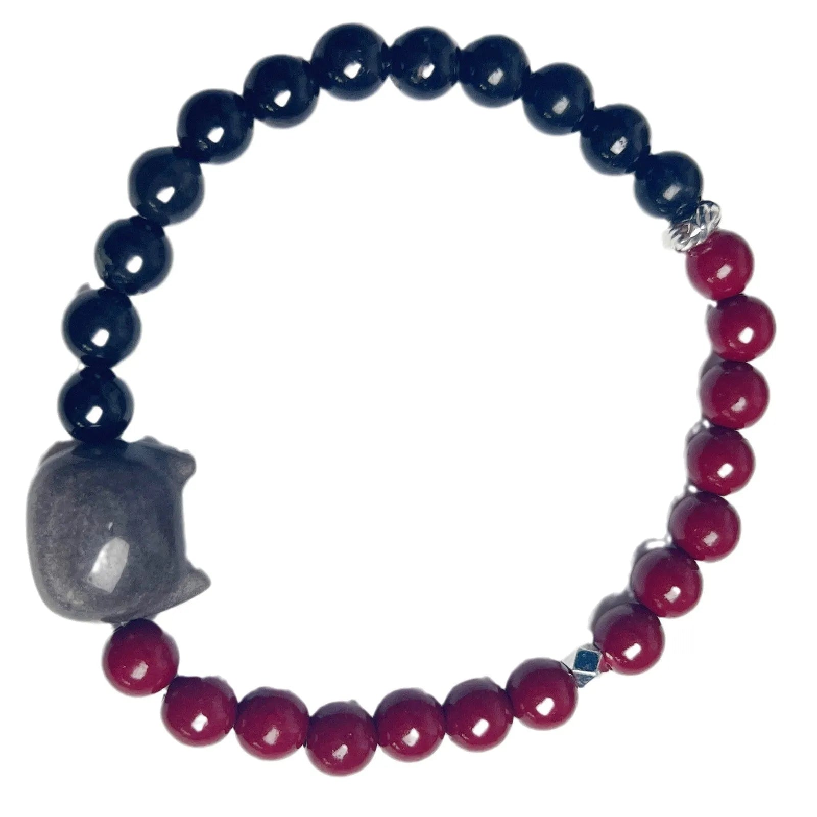 Handmade obsidian and glass bead bracelet with a cat charm and red string, showing adjustable stainless steel clasp.