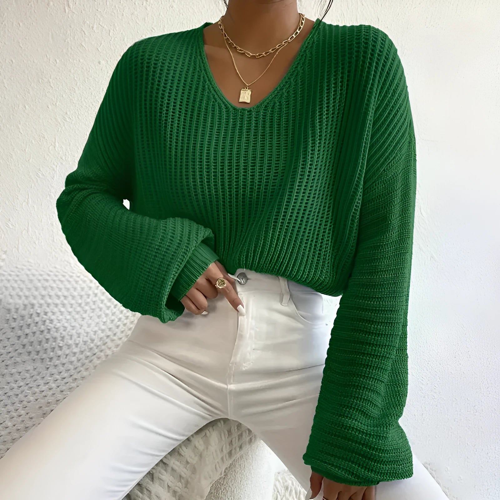 A woman wearing a solid colour long sleeve polyester pullover in a casual, loose fit.