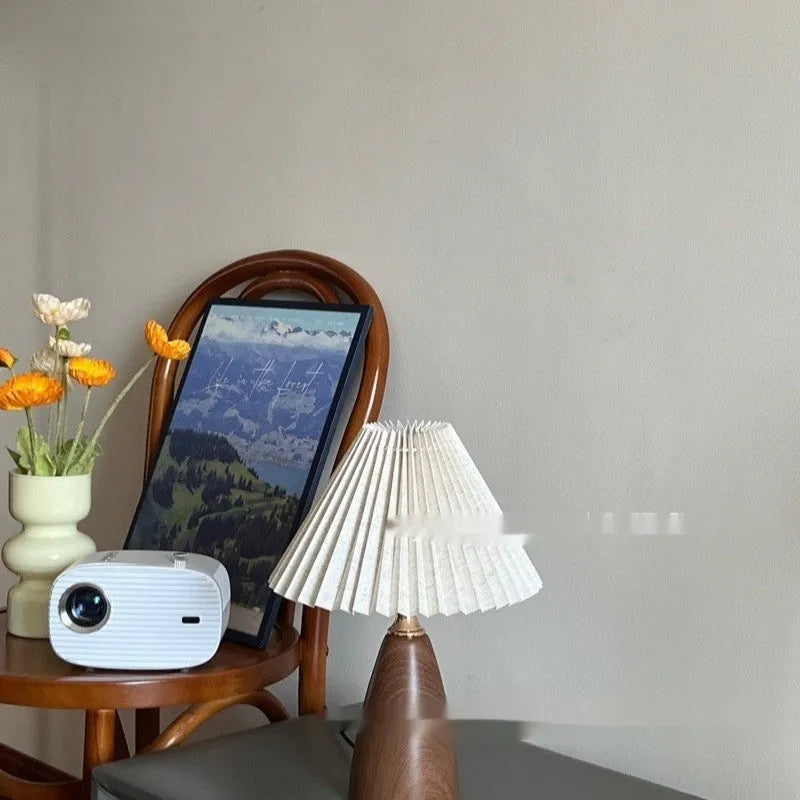 Nordic retro ceramic table lamp with a pleated tapered floral shade on a bedside table.