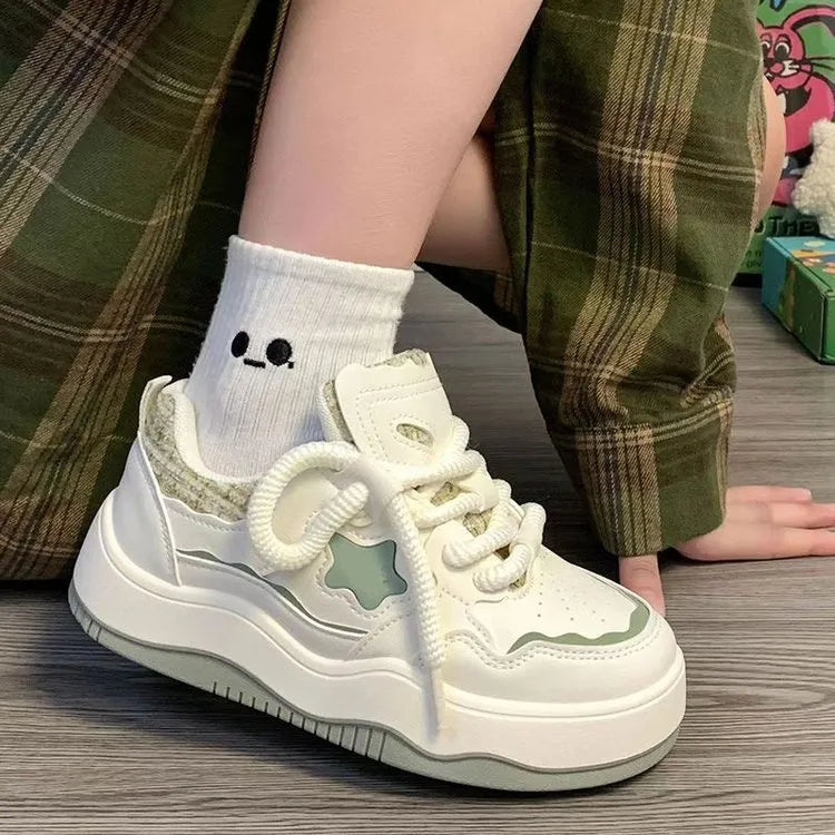 Women's green platform sneakers with round toe and lace-up closure on rubber sole