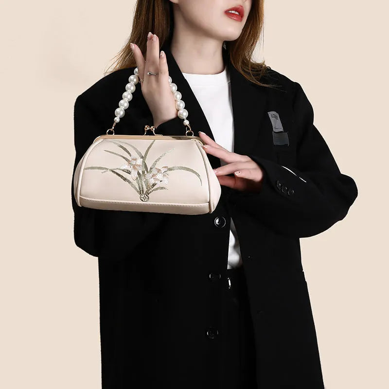 Beige women's shoulder bag with embroidery on soft PU leather in shell shape