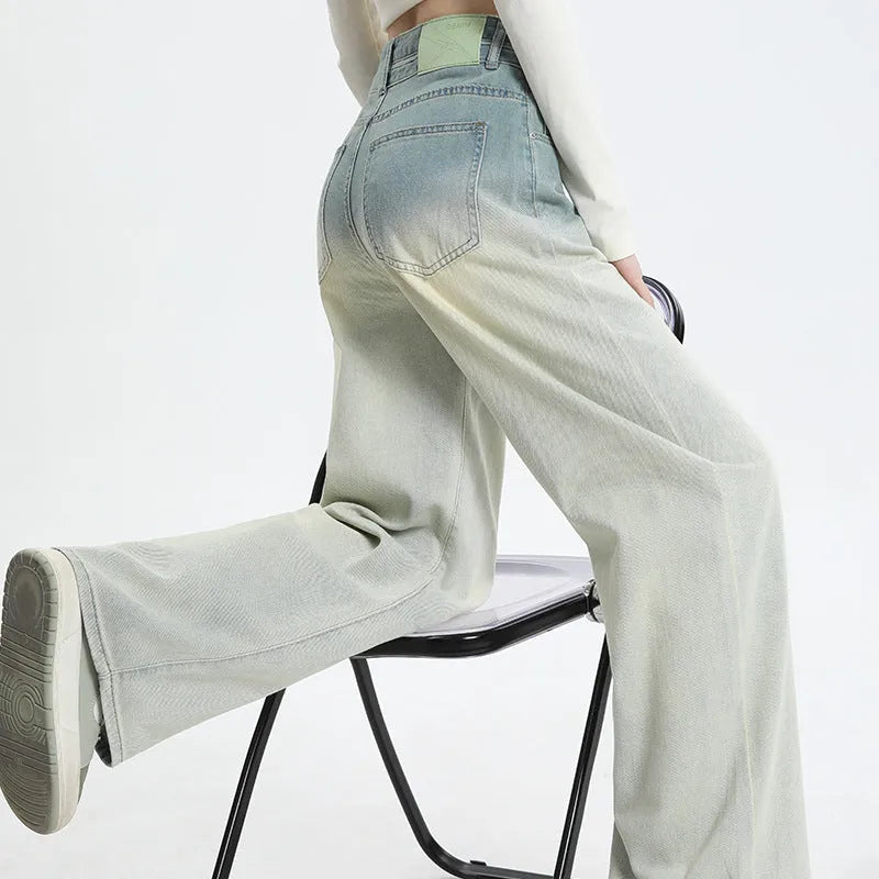 Women's gradient blue wide-leg denim trousers on a neutral background.