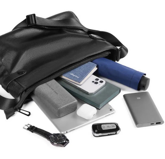 Men's black genuine leather and cowhide crossbody messenger bag with waterproof function and patchwork detail.