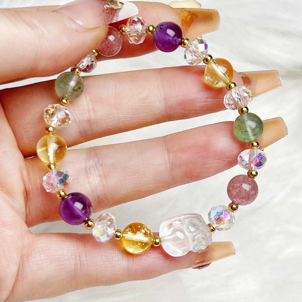 Close-up of a manually crafted crystal bracelet with a nine-tail fox centrepiece on a wrist.
