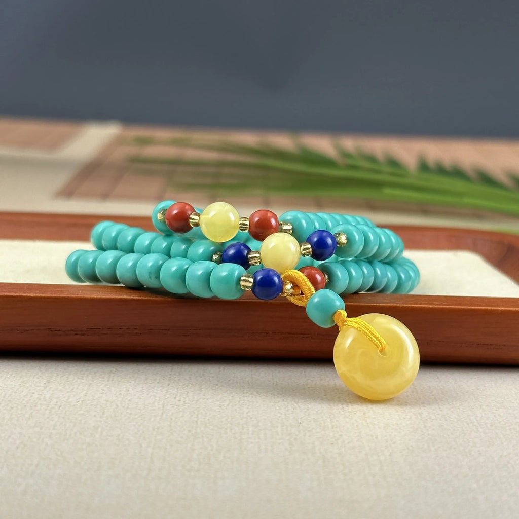 Turquoise necklace with a hand-woven stone mesh flower lucky pendant on a ball bead chain.
