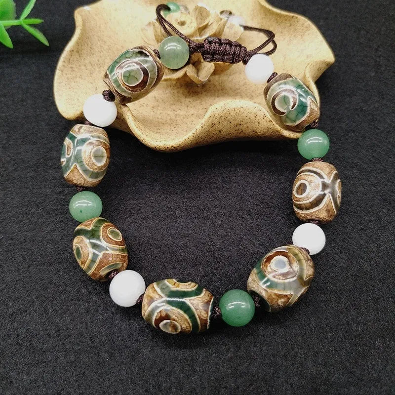 Green agate ethnic bracelet with three eye Tibet beads in hand-woven geometric pattern