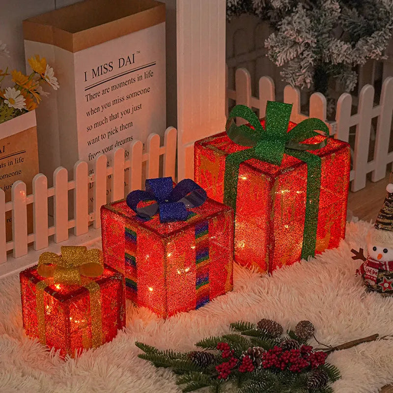 Set of three pre-lit Christmas gift box decorations with fabric bows and LED lights