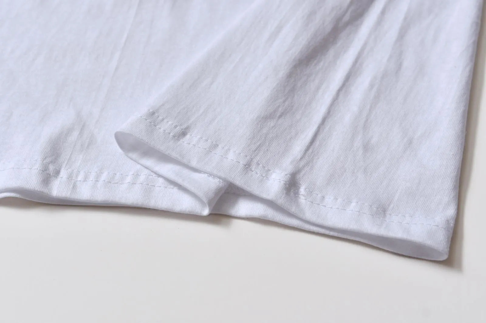 White patterned cotton pullover top with short sleeves on a hanger