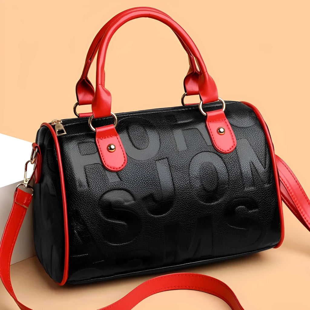 Red cylindrical crossbody bag with three straps and authentic leather tactile feel