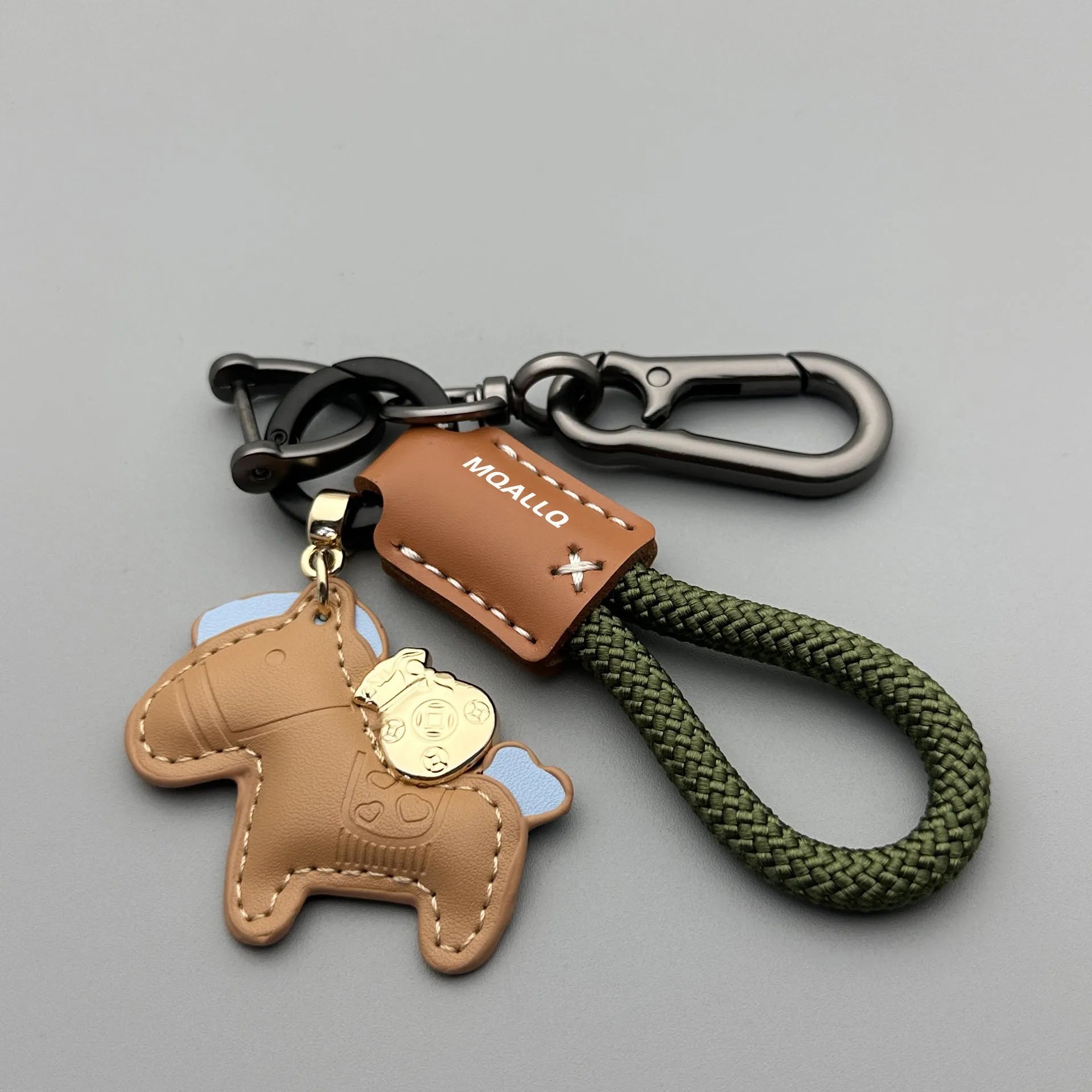 Handmade brown cowhide leather keychain with a silver pony belt buckle charm and green velvet rope.