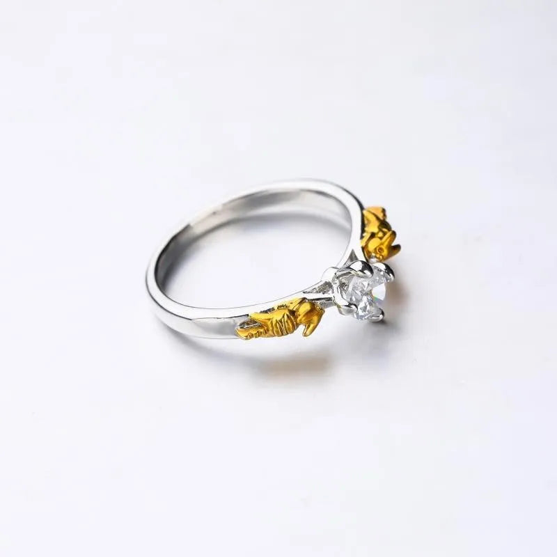 Detailed close-up of a black gold copper crown ring with a central crystal on a finger.
