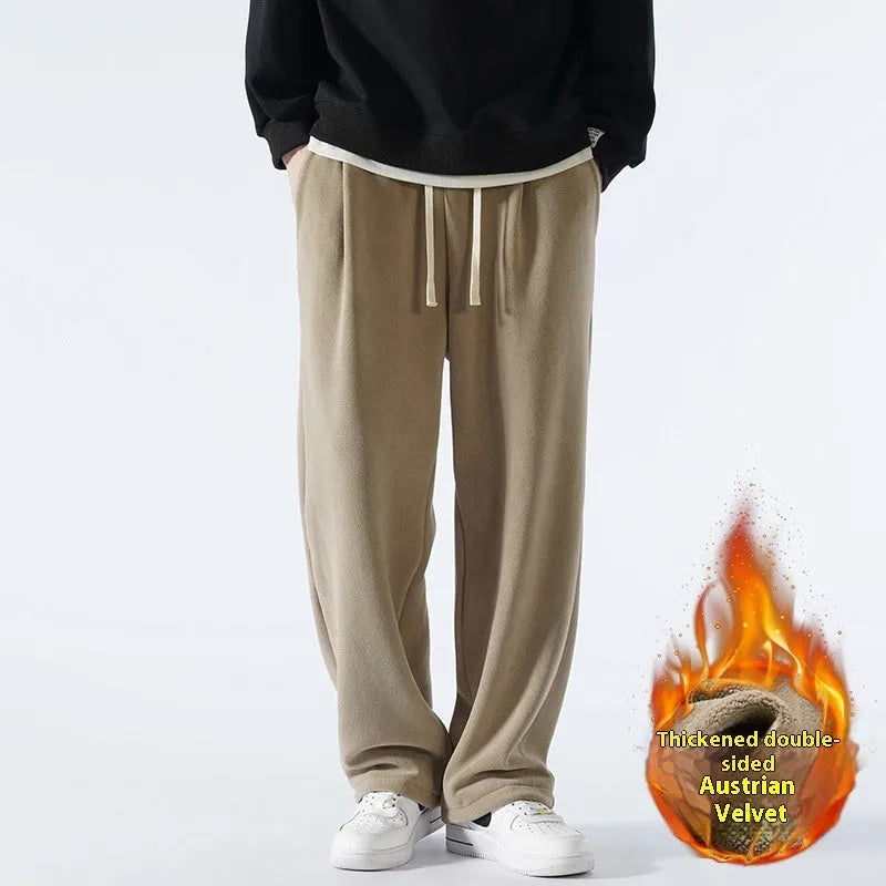 Men's apricot fleece-lined casual sports trousers with a loose fit and drawstring waist, laid flat.