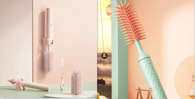 Pink and green electric baby bottle brush with rotating silicone head and USB charging cable