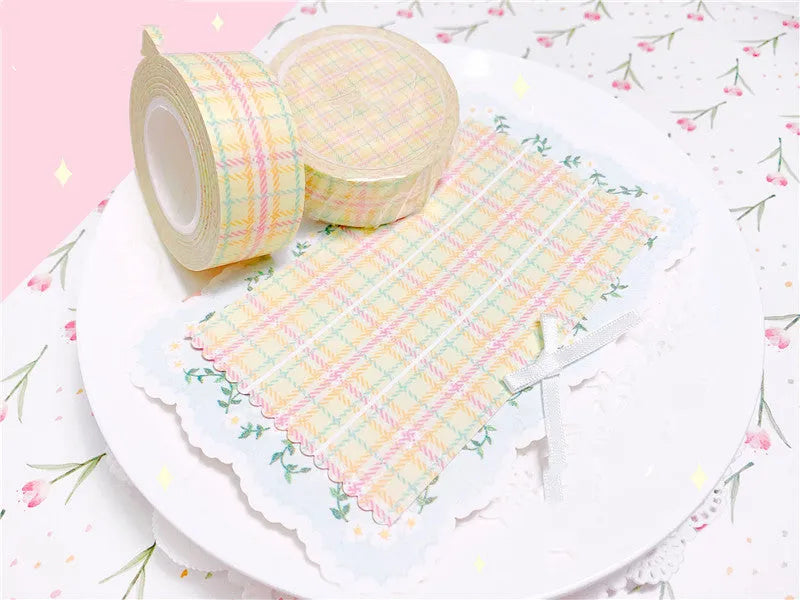 Eight rolls of decorative plaid paper tape in blue green pink purple and yellow with release paper backing 2cm x 10M