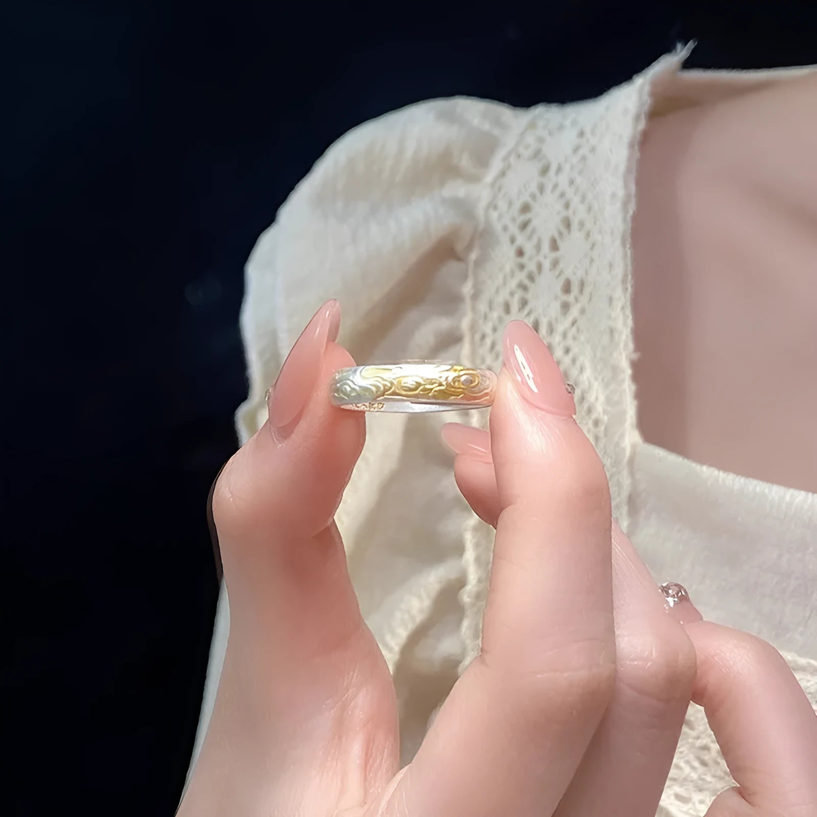 Geometric open-mouth silver and gold ring with a Xiangyun cloud pattern on a white copper band.