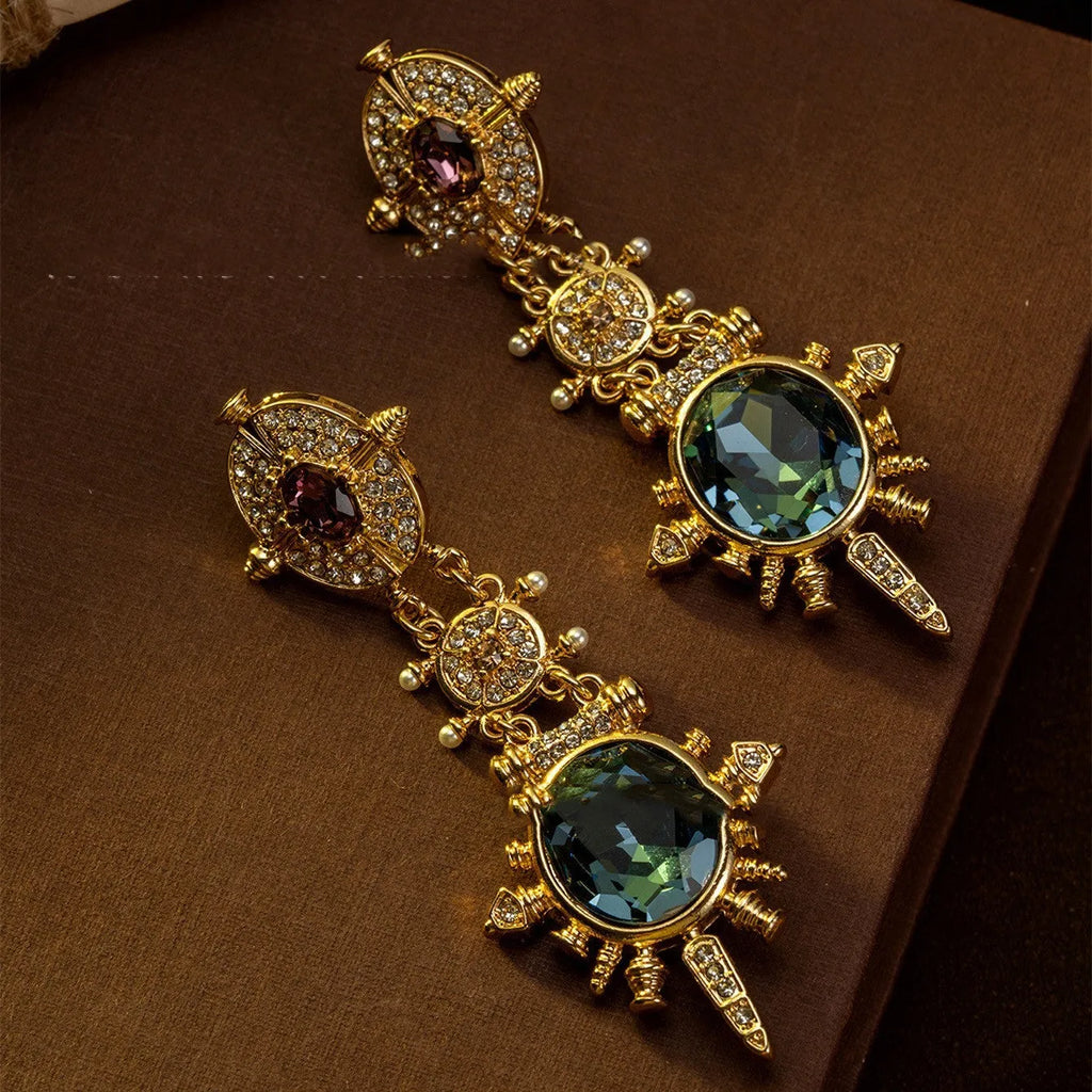 A pair of gold geometric retro-style alloy stud earrings with round diamond-treatment details.