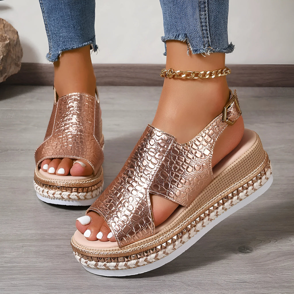 Gold women's Roman sandals with hollow-out design and an ankle buckle fastening.
