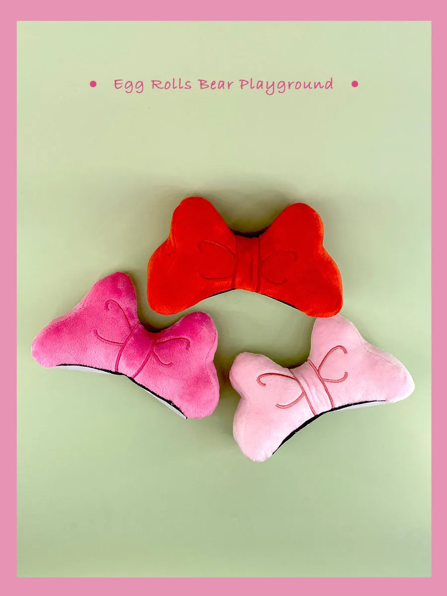 Soft plush bow helmet decoration in red, pink, or rose pink for motorcycle or ski helmet customisation.