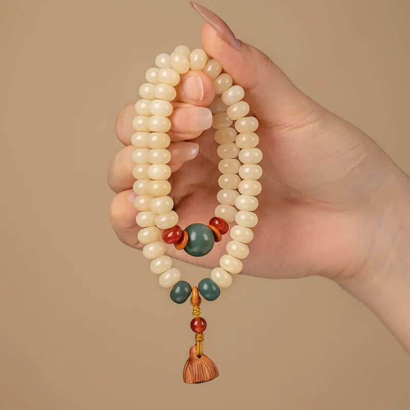 Women's wooden Bodhi root bracelet with 6x9mm flat round beads in cream colour