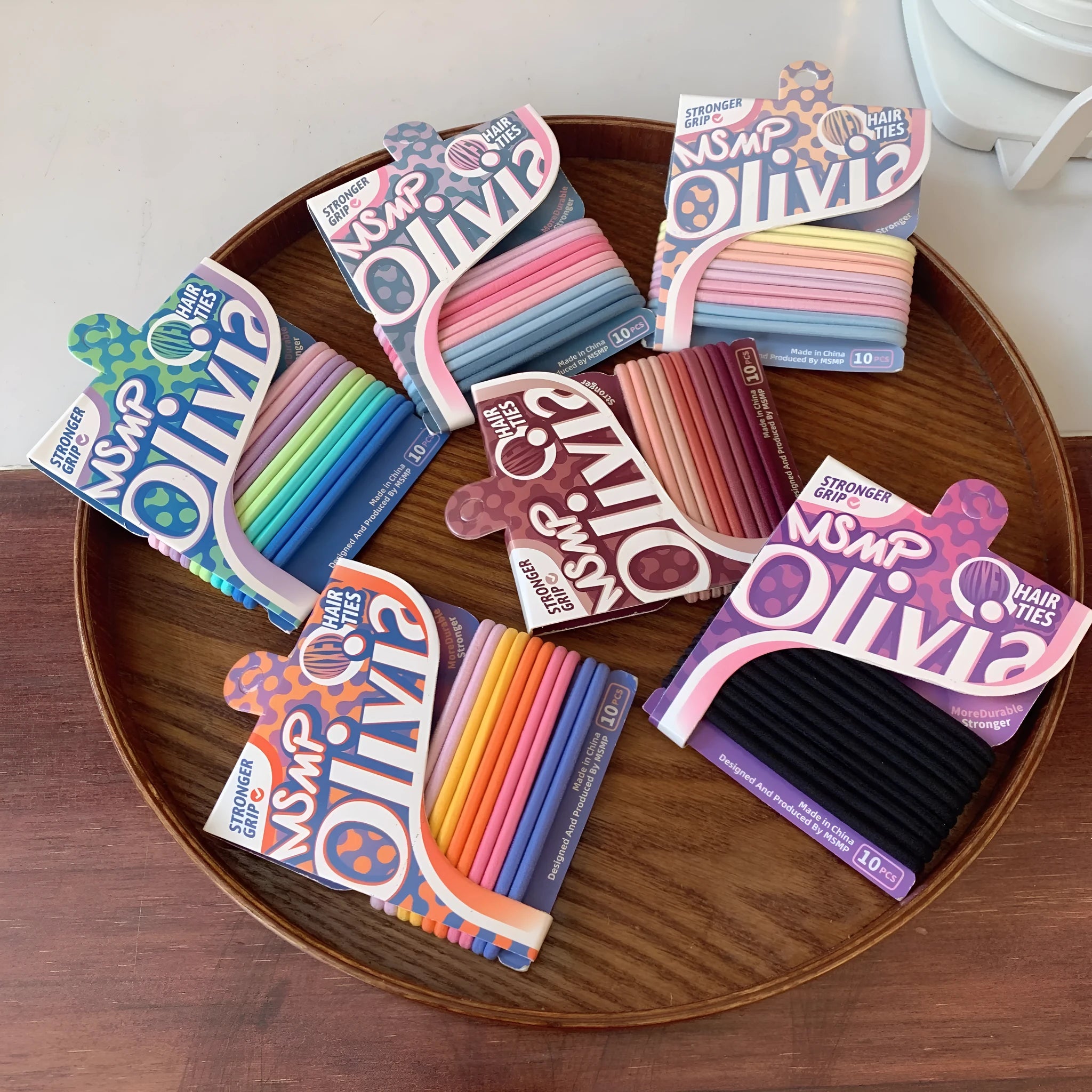 Candy colour elastic hair bands with braided design stretched to show length