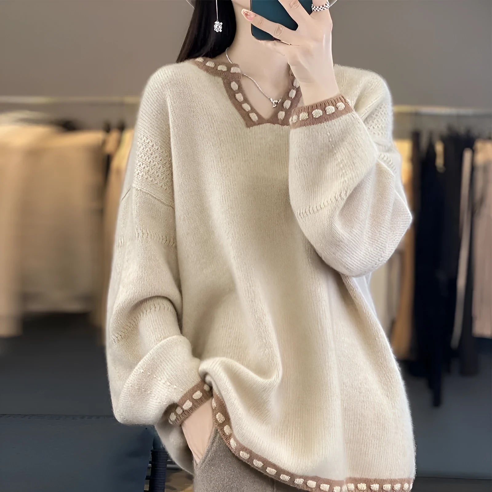Women's camel V-neck viscose sweater with long sleeves on a hanger.